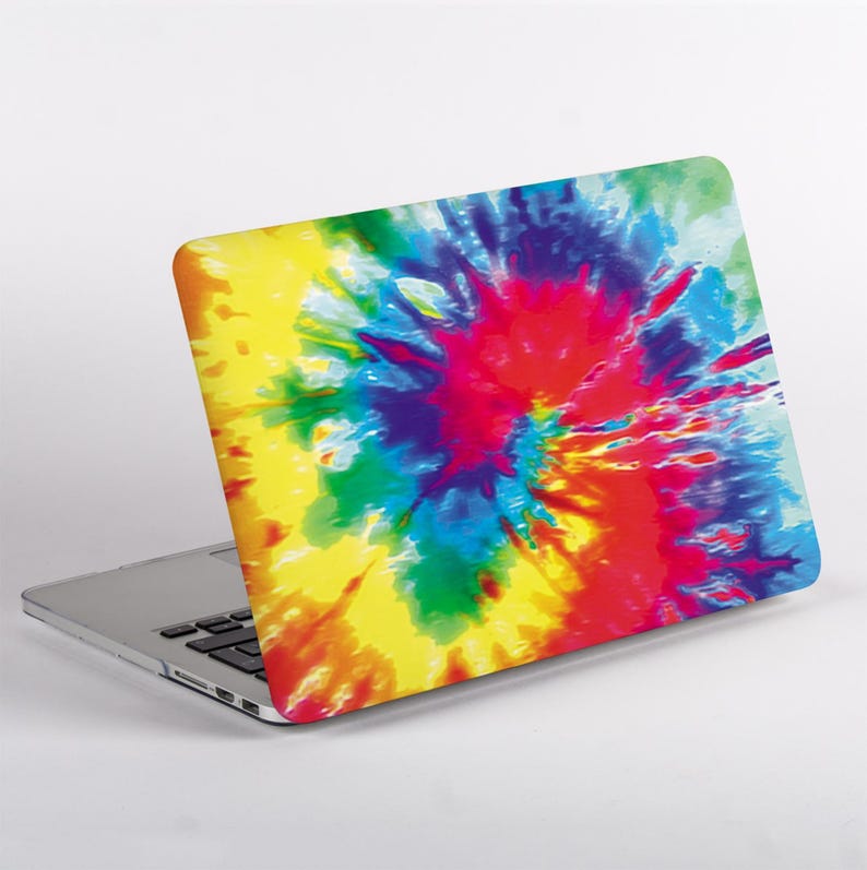 May include: A laptop computer featuring a vibrant tie-dye pattern on its lid. The design displays a swirling explosion of bright colors including yellow, red, blue, green, and purple, radiating from a central point across the entire surface.