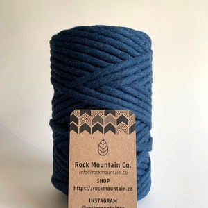 May include: A roll of dark blue cotton rope with a brown paper tag that says "Rock Mountain Co. info@rockmountain.co SHOP https://rockmountain.co INSTAGRAM @rockmountainco"