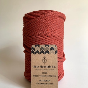May include: A spool of thick, red cotton rope with a brown paper tag that reads "Rock Mountain Co. info@rockmountain.co SHOP https://rockmountain.co INSTAGRAM @rockmountainco"
