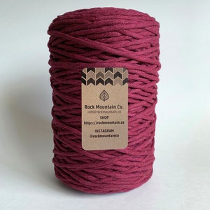 May include: A spool of deep burgundy cotton cord with a brown label that reads "Rock Mountain Co. info@rockmountain.co SHOP https://rockmountain.co INSTAGRAM @rockmountainco"