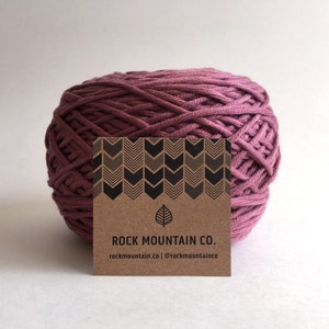 May include: A ball of deep pink cotton rope with a brown paper tag that reads "ROCK MOUNTAIN CO. rockmountain.co | @rockmountainco"