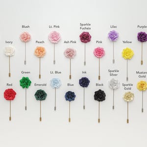 a collection of 24 pin cuffs, each with a different color rose attached, arranged in a grid-like pattern on a white background.