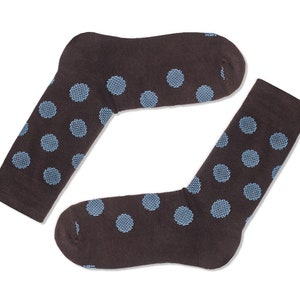 May include: A pair of brown socks with a blue polka dot pattern.