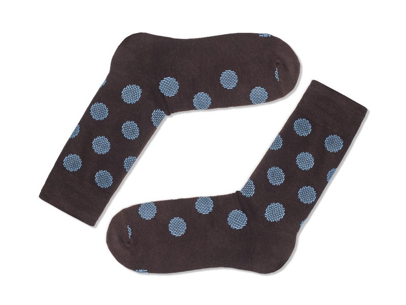 May include: A pair of brown socks with a blue polka dot pattern.