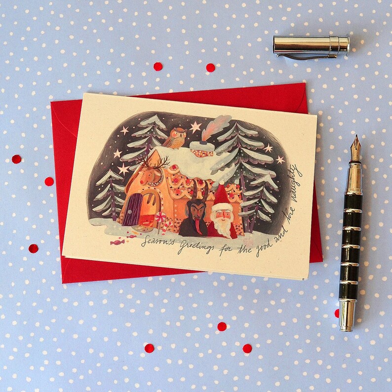 May include: A Christmas card with a gingerbread house in a snowy forest. The house has candy cane decorations and a red-suited figure standing in front of it. The text on the card reads "Seasons Greetings for the good and the naughty".