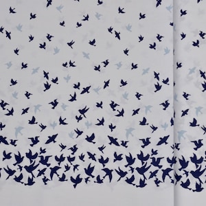 May include: White fabric with a repeating pattern of dark blue birds flying in different directions. The birds are scattered across the fabric, creating a dynamic and lively design.
