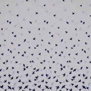 May include: White fabric with a repeating pattern of dark blue birds flying in different directions. The birds are scattered across the fabric, with a higher density of birds at the bottom of the fabric.