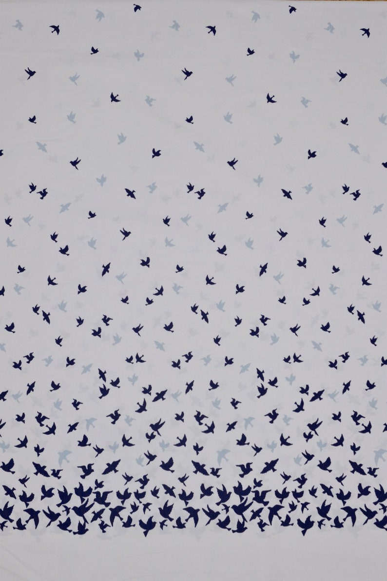 May include: White fabric with a repeating pattern of dark blue birds flying in different directions. The birds are scattered across the fabric, with a higher density of birds at the bottom of the fabric.