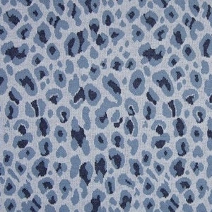 May include: A blue and white fabric with a leopard print pattern. The fabric has a textured, woven look.