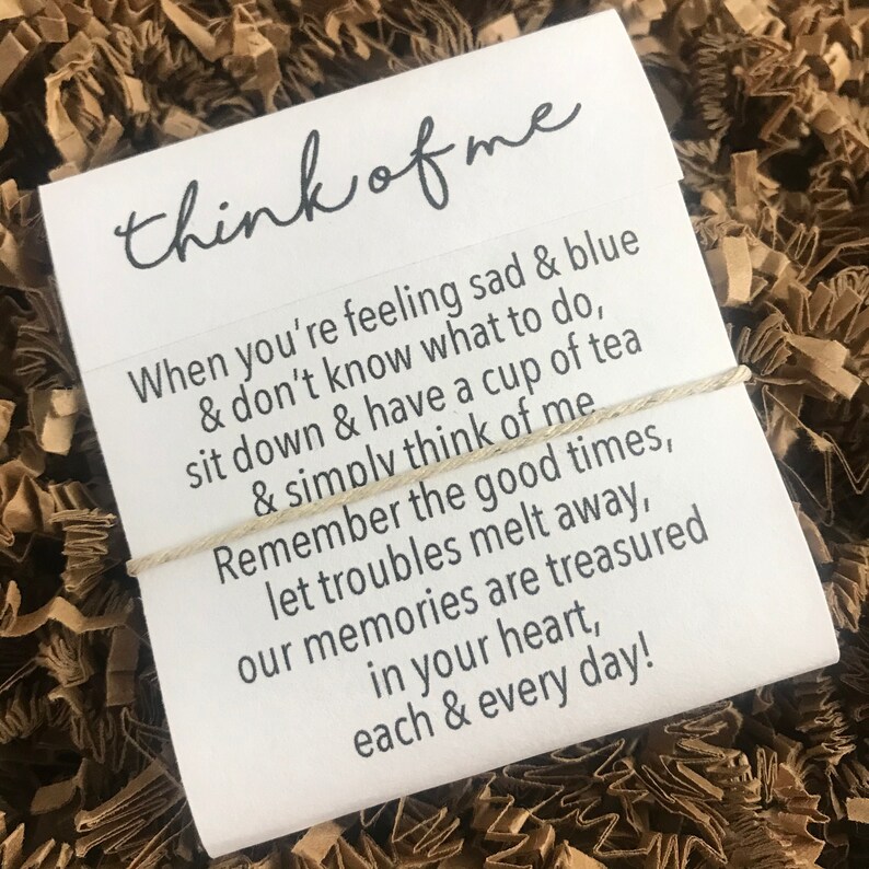May include: A white card with a handwritten message that reads "think of me". The message continues with a poem about remembering good times and letting troubles melt away.