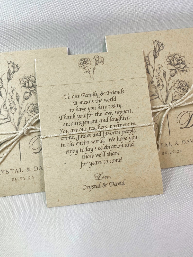 May include: A brown card with a floral design and the text "To our Family & Friends It means the world to have you here today! Thank you for the love, support, encouragement and laughter. You are our teachers, partners in crime, guides and favorite people in the entire world. We hope you enjoy today's celebration and those we'll share for years to come! Love, Crystal & David"