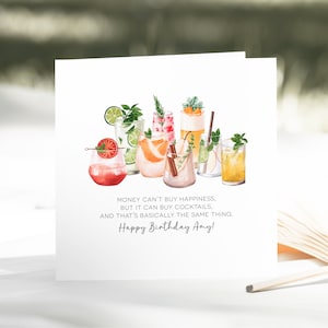 May include: White greeting card featuring watercolor illustrations of various cocktails. The card includes the text: "Money can't buy happiness, but it can buy cocktails, and that's basically the same thing. Happy Birthday Amy!"