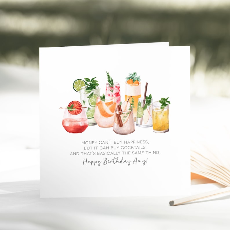 May include: White greeting card featuring watercolor illustrations of various cocktails. The card includes the text: "Money can't buy happiness, but it can buy cocktails, and that's basically the same thing. Happy Birthday Amy!"