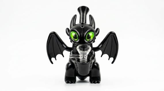 A hand-crafted glass figurine of Toothless that doubles as a desk sculpture — the kind of collectible that looks like it belongs in a curiosity cabinet, not a gift shop.