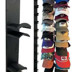 May include: A vertical black wall-mounted hat rack featuring multiple curved hooks designed to hold baseball caps. The rack is shown empty on the left and fully loaded with a variety of colorful baseball caps on the right side.
