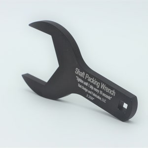 May include: A black metal wrench labeled "Shaft Packing Wrench" with the instructions "Tighten until 1 drip every 10 seconds" and "York Design and Fabrication, LLC" and the measurement "2.250".
