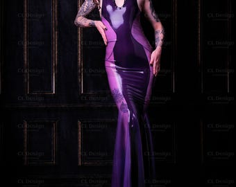 May include: A woman wearing a purple and pink latex dress with a halter neckline. She has red hair and tattoos on her arms. The background is a dark, textured wall.