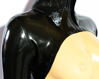 May include: Black latex top with a zipper closure and a floral design. The top has long sleeves and a high neckline.