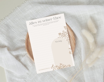 May include: A white printable notepad with gold floral accents and the text "Alles zu seiner Ehre" and "Wichtig". The notepad is on a wooden surface with a white fabric background.