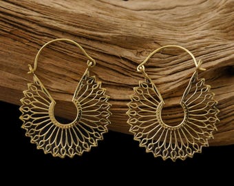May include: A pair of gold-toned hoop earrings with a delicate, intricate design. The earrings are made of metal and have a circular shape with a floral pattern.