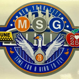 May include: A blue and orange circular sticker with the text "NEW YORK CITY" and "TIME FOR A BIRD TO FLY". The sticker features a white goose with outstretched wings, a taxi cab, a red apple with a heart and the number 25, and three circles with the letters "M", "S", and "G".