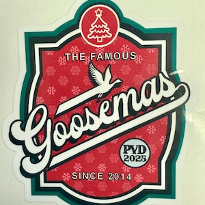 May include: A sticker with a red background and white snowflakes, featuring the text "The Famous Goosemas" in a stylized font. A white bird flies across the design, with a Christmas tree icon and the text "PVD 2025" and "Since 2014".