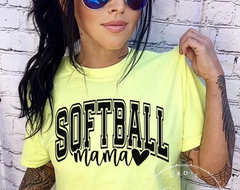 May include: A neon yellow t-shirt with black text that reads "Softball mama" with a black heart. The model is wearing the shirt and has a black ponytail and blue mirrored sunglasses.