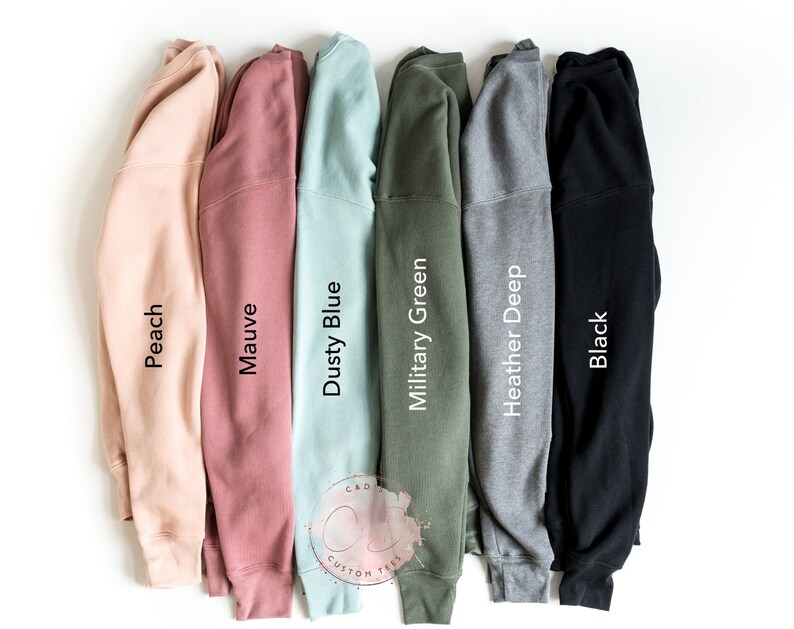 May include: Six different colored sweatshirts, from left to right: peach, mauve, dusty blue, military green, heather deep, and black.