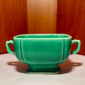 May include: A set of three ceramic mugs with a speckled, matte finish. The mugs are in shades of cream, light gray, and dark gray. Each mug has a simple, minimalist design, perfect for coffee or tea.