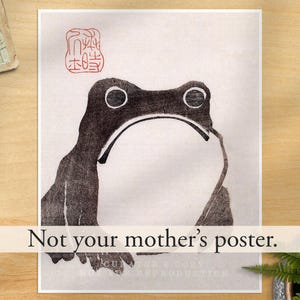 May include: A rectangular poster featuring a black ink illustration of a frog with a large white belly. A red square stamp with intricate characters is positioned in the top left corner. The text "Not your mother's poster." is printed in black.