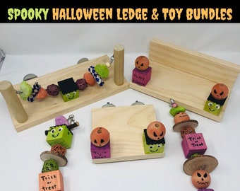May include: A set of three wooden Halloween-themed bird perches for small pets. The perches feature a variety of colors, including orange, green, purple, and brown. The perches are decorated with small wooden pumpkins, ghosts, and bats. The perches are also decorated with the words "Trick or Treat".