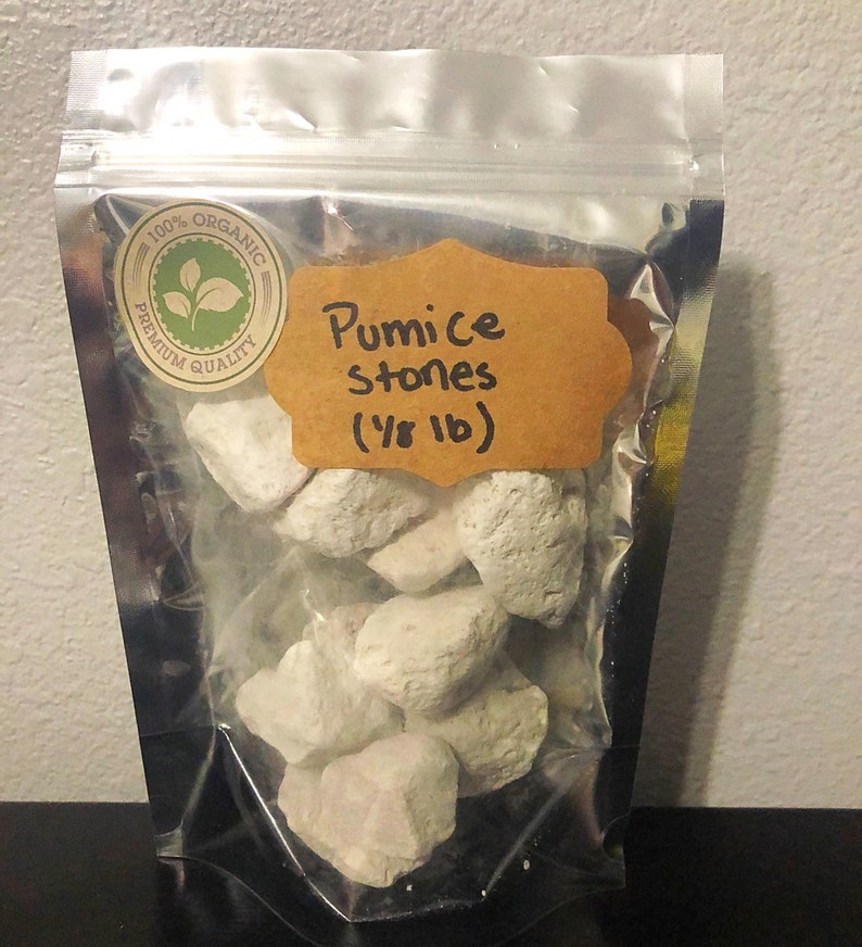 May include: A clear plastic bag filled with white pumice stones. The bag has a label that says "100% Organic Premium Quality" and "Pumice Stones (1/8 lb)".