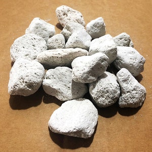 May include: A pile of white pumice stones, a natural abrasive used for cleaning and exfoliating.