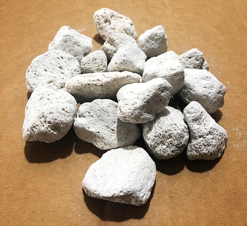 May include: A pile of white pumice stones, a natural abrasive used for cleaning and exfoliating.