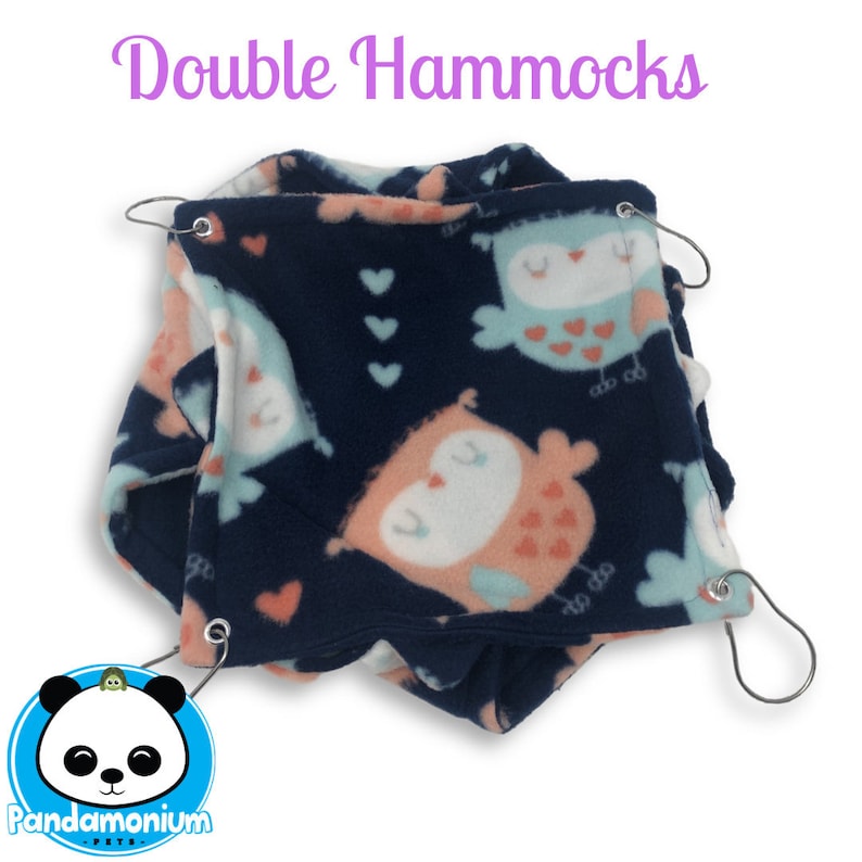 May include: A double hammock for small pets, made of soft blue fleece with a pink and blue owl print. The hammock has two metal hooks for hanging.