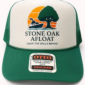 May include: Green and white trucker hat with a graphic of a boat, tree, and sun. The hat features the text "STONE OAK AFLOAT" and "LEAVE THE WALLS BEHIND". The hat also has a "OTTO" label.