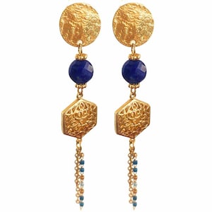 May include: Gold earrings with a blue gemstone, a hexagonal charm, and a chain with blue and white beads.