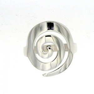 May include: A silver ring with a spiral design. The ring is made of polished metal and has a smooth finish.