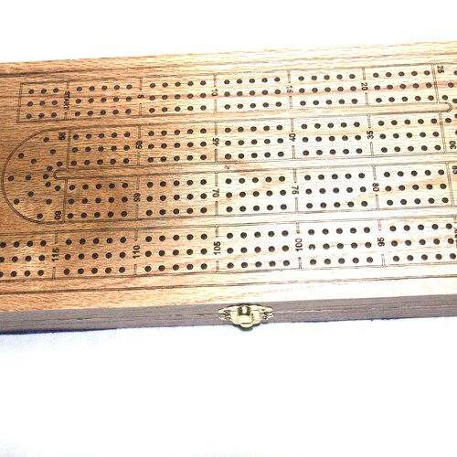 Cribbage Boards in various designs and Materials. Includes Pegs and