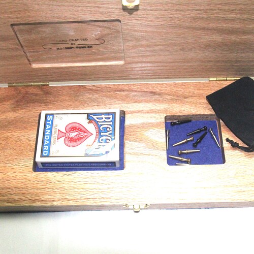 Cribbage Boards in various designs and Materials. Includes Pegs and