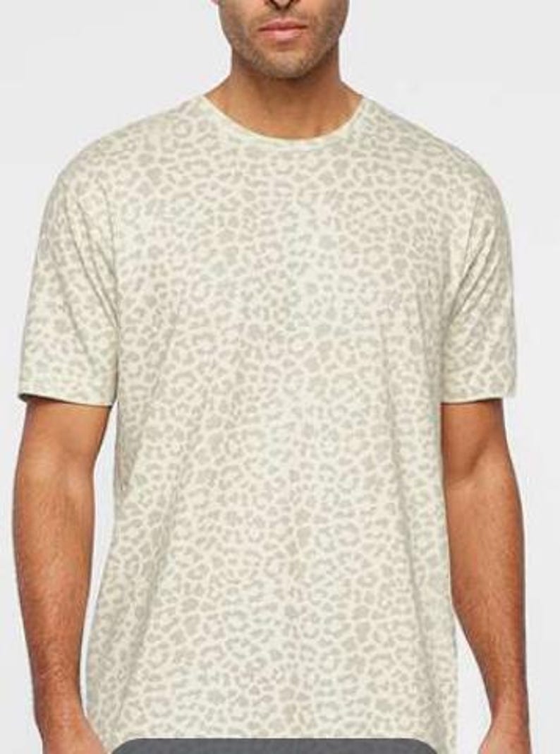 May include: A white t-shirt with a brown leopard print pattern.