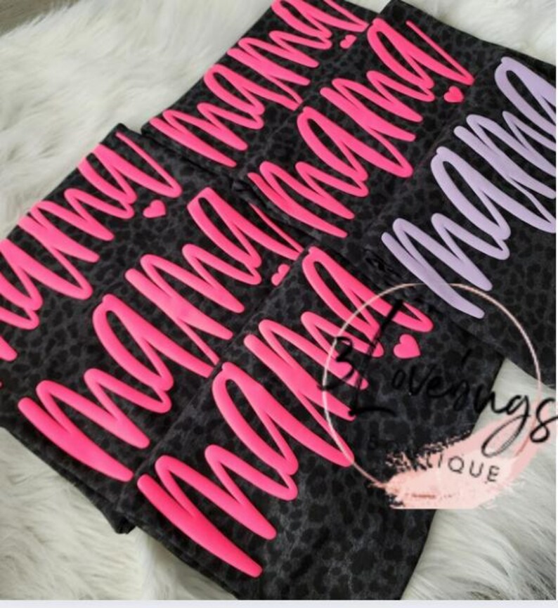 May include: Three black and white leopard print fabric pouches with the word "mama" written in pink and purple lettering.
