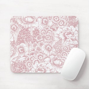 May include: A pink floral mouse pad with a white mouse on top. The mouse pad features a detailed floral pattern with a variety of flowers and leaves.