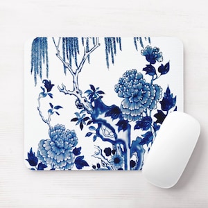 May include: Blue and white floral design mouse pad with a traditional Chinese pattern. The design features a tree with flowers and leaves.
