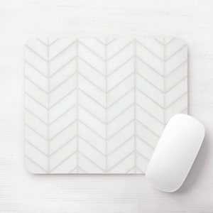 May include: White mouse pad with a chevron pattern. The mouse pad is made of a smooth, durable material and is perfect for protecting your desk from scratches.