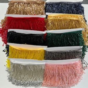 May include: Assortment of ten different colors of beaded fringe trim. The fringe is made of small, round beads that are strung together to create a long, flowing fringe. The colors include gold, black, red, green, yellow, silver, pink, and more.