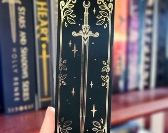 Marcador de lámina dorada con forma de espada caprichosa