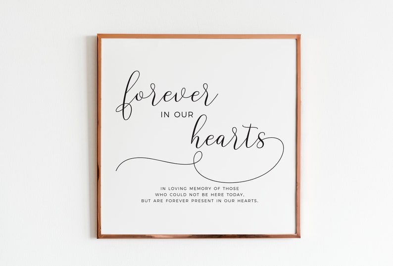 May include: A framed print with the text "forever in our hearts" in a cursive font. The text is in black on a white background. Below the text is a smaller quote that reads "In loving memory of those who could not be here today, but are forever present in our hearts."