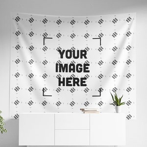 a white wall hanging over a white dresser