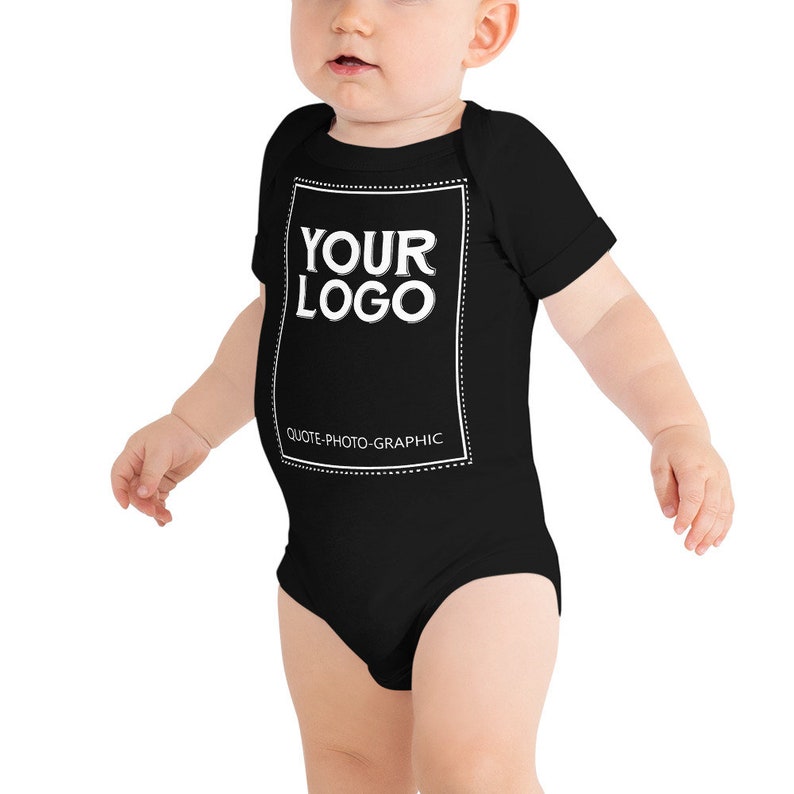 a baby wearing a black bodysuit with the words your logo on it